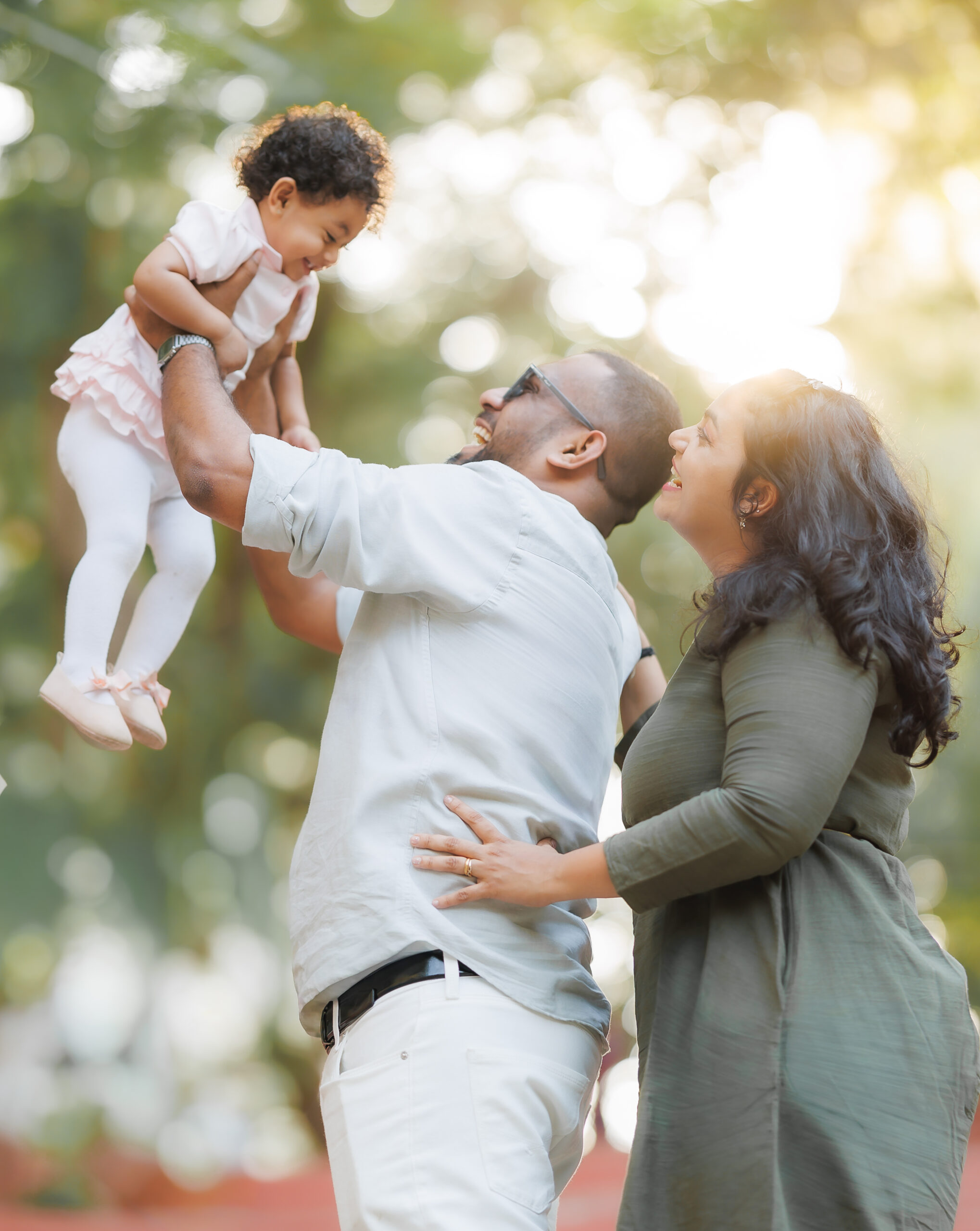 Family laughing together outdoors during a photography session in London