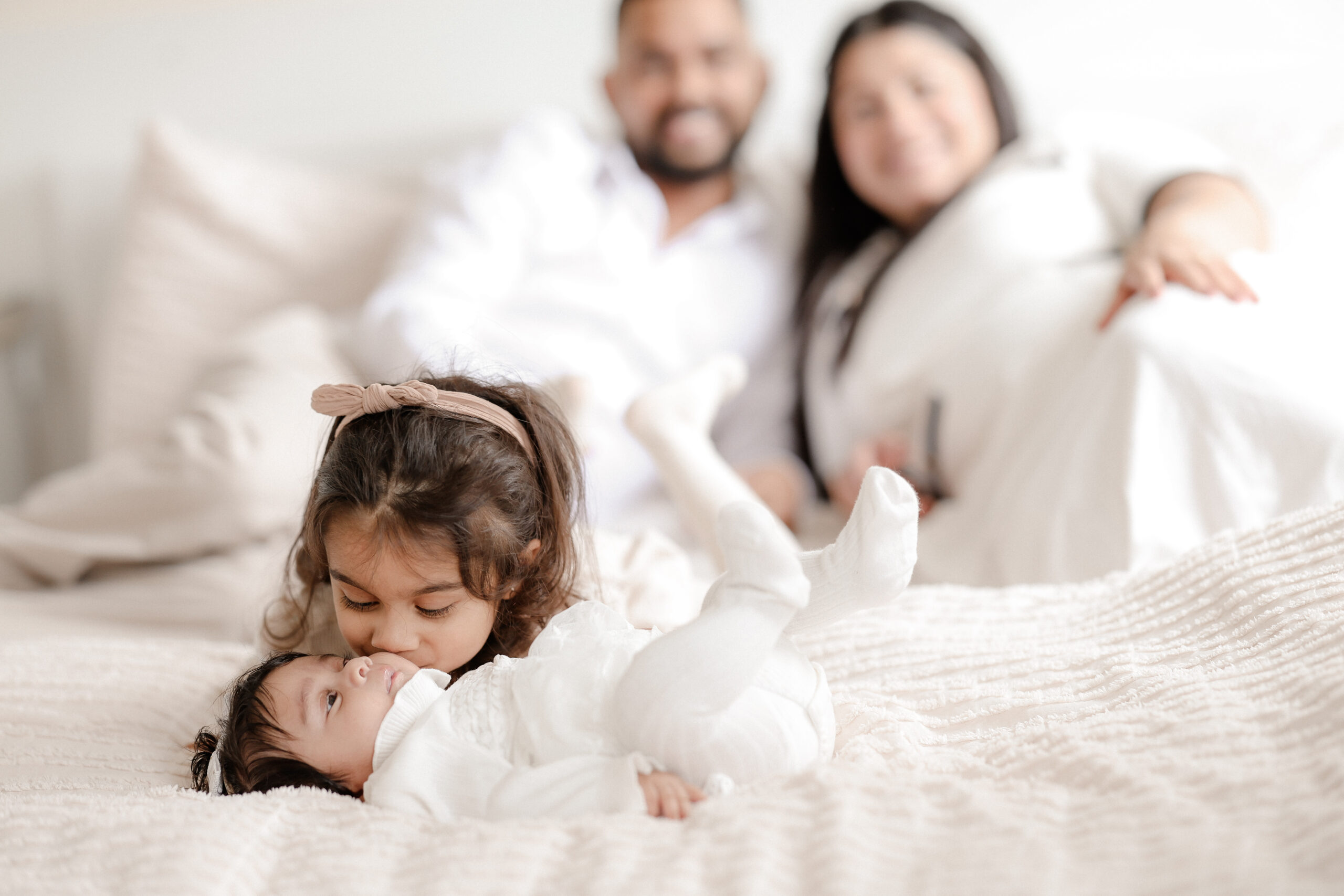 A family laughing together during a Little Grins photography session in Surrey